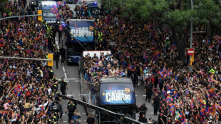 Barca fans celebrate league titles with players in parade